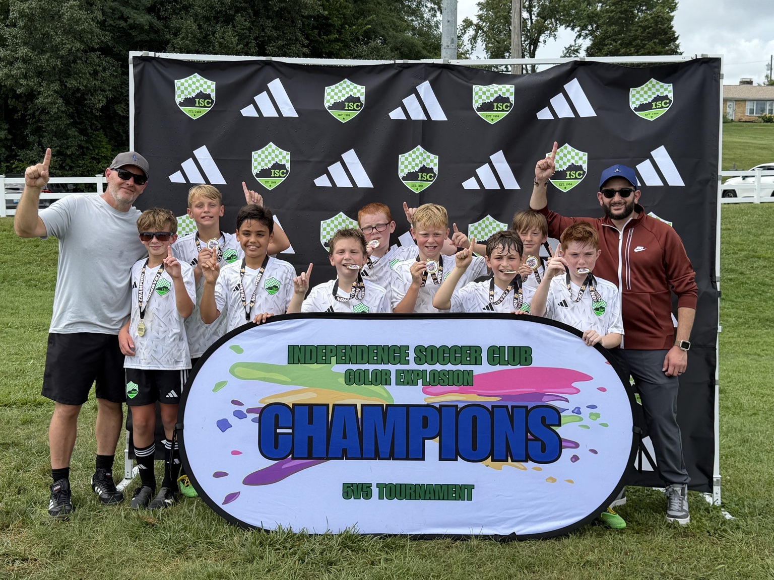 Titans players and coaches with their ISC Color Explosion champions sign