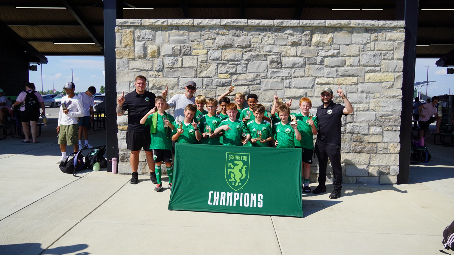 Green Titans celebrating with the Lexington champions banner